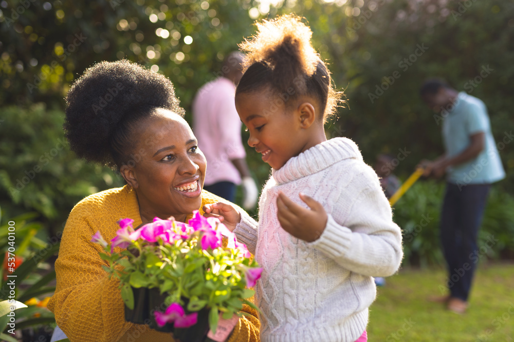 African american family spending time together in the garden and gardening