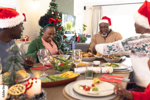 Happy african american family spending time together and having christmas meal