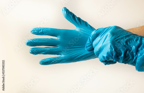 Blue medical gloves on hands. Health protection. © Olena