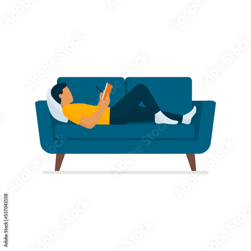 Man lying on the couch and writing