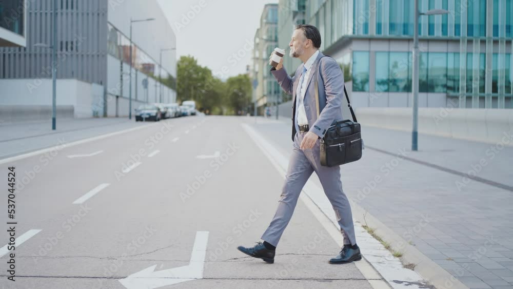 Successful senior business man outside the office. Handsome man with business suit going home after work. Corporate and lifestyle moments in the financial district of the city Successful senior business man outside the office. Handsome man with business suit going home after work. Corporate and lifestyle moments in the financial district of the city