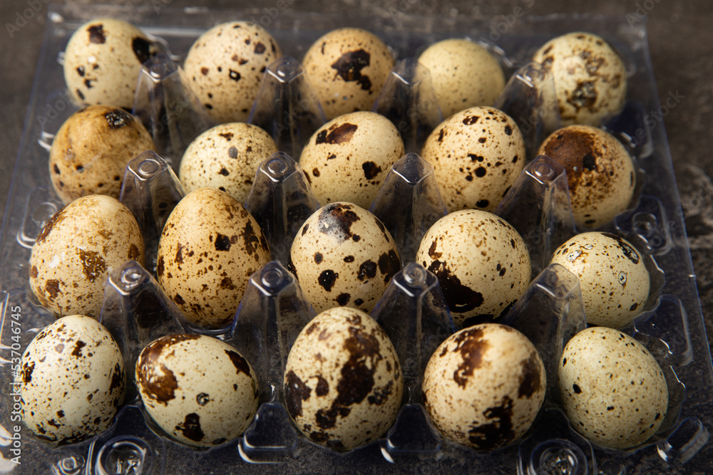 Quail eggs on black texture background. Whole and broken quail eggs. Natural products. Place for text. Fresh quail eggs. Protein. Calcium.