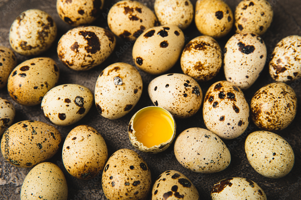 Quail eggs on black texture background. Whole and broken quail eggs. Natural products. Place for text. Fresh quail eggs. Protein. Calcium. Quail eggs on black texture background. Whole and broken quail eggs. Natural products. Place for text. Fresh quail eggs. Protein. Calcium.