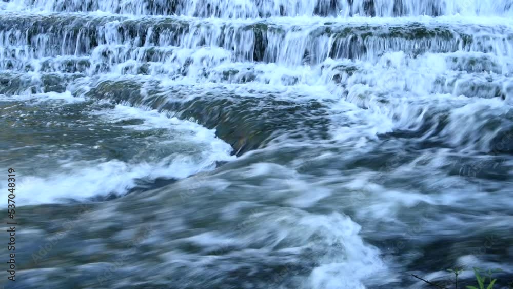 A stunningly beautiful stepped waterfall shot with a slow shutter speed to capture motion flows down river to a bigger waterfall in Tennessee's Burgess National Park.