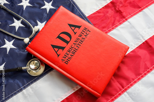 Foto American flag, book The Americans with Disabilities Act ADA law and stethoscope