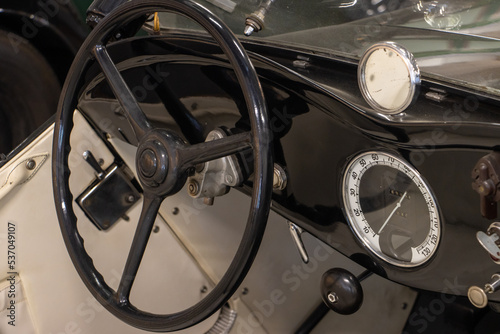 Steering wheel with dashboard in the interior of a sport-style vintage car