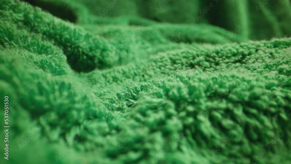 Texture of green soft terry towel textile.