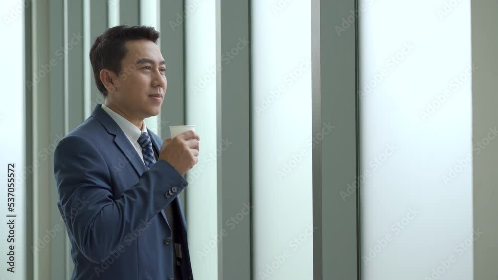 Asian businessman relaxing and drinking a coffee. Asian businessman relaxing and drinking a coffee.