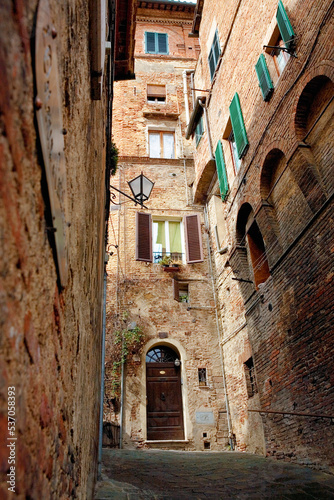 Fototapeta Naklejka Na Ścianę i Meble -  A steep lane, Via di Castelvecchio, Contrada della Tartuca, Siena, Tuscany, Italy