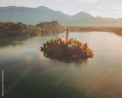 Aerial view of the church Marijinega Vnebovzetja at sunset, Lake Bled, Slovenia. photo