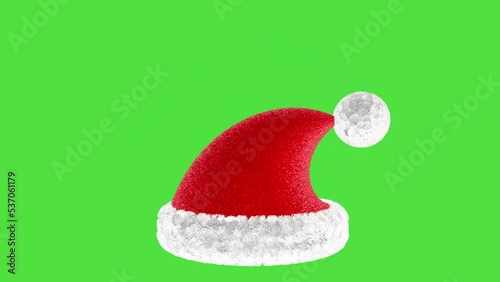 3D animation of a red Santa Claus hat on a green screen.