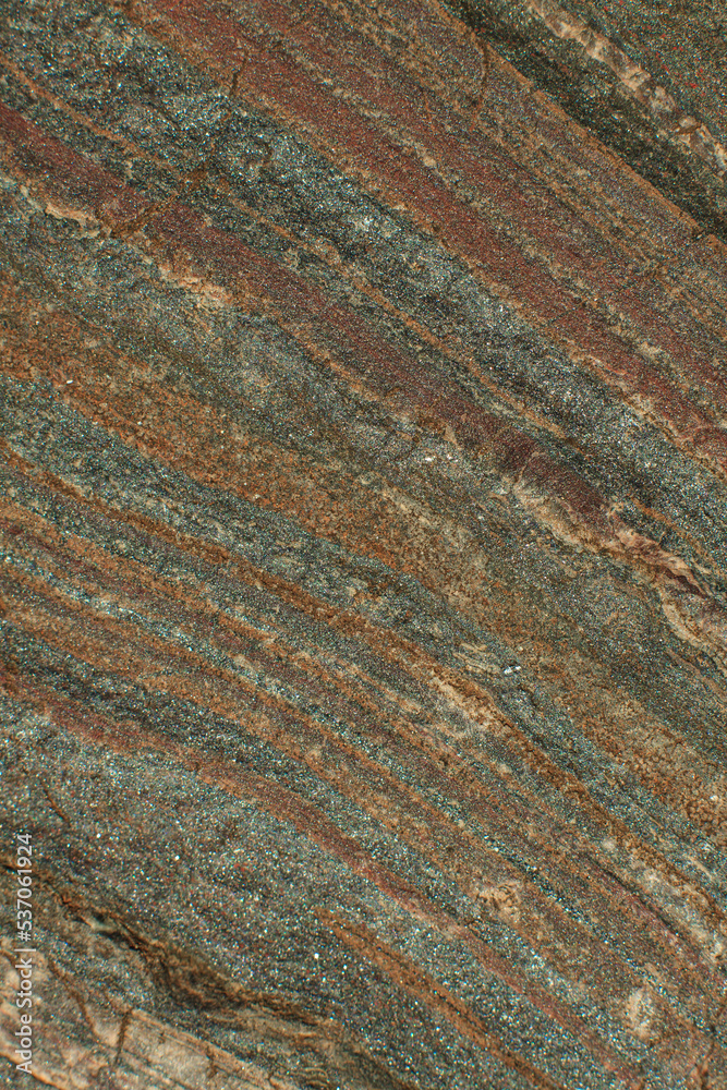 Photo of the texture of natural stone. The heterogeneous background of dark stone