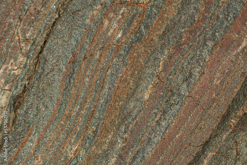 Photo of the texture of natural stone. The heterogeneous background of dark stone