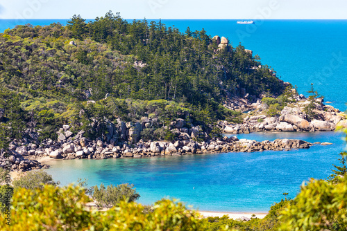 Fototapeta Naklejka Na Ścianę i Meble -  aerial view of paradise beach with turquoise water on magnetic island, small paradise bay surrounded by rocks, beach holiday in queensland, australia
