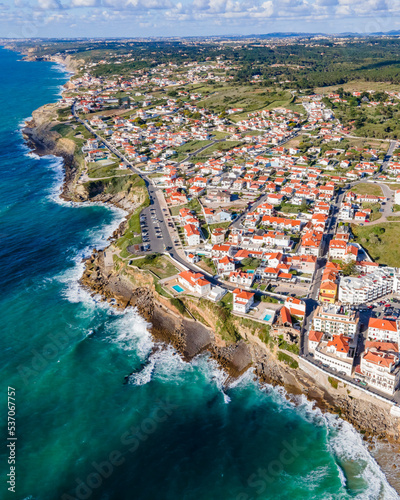 Aerial view of Praia das Macas little township along south Portuguese coastline facing the Atlantic Ocean, Colares, Portugal. photo