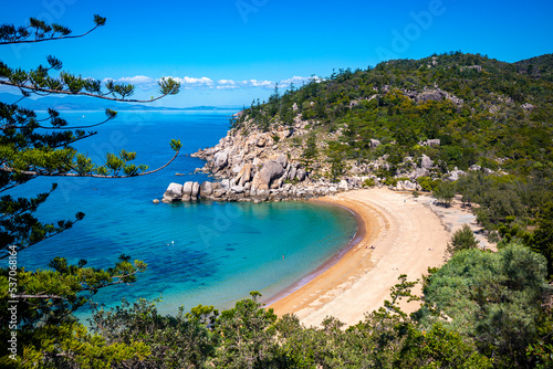 aerial view of paradise beach with turquoise water on magnetic island, small paradise bay surrounded by rocks, beach holiday in queensland, australia