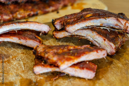 Сutted tasty smoked pork ribs on wooden desk