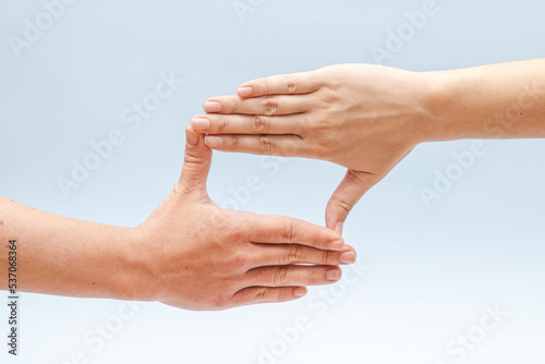 Two hands gesturing on a blue background