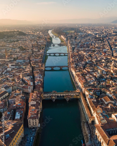 Aerial view of Florence skyline along Arno river at sunset with Ponte Vecchio bridge in foreground, Florence, Tuscany, Italy. photo