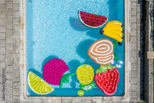 Aerial view of floating object fruit shaped in a swimming pool, Chavannaz, France. photo