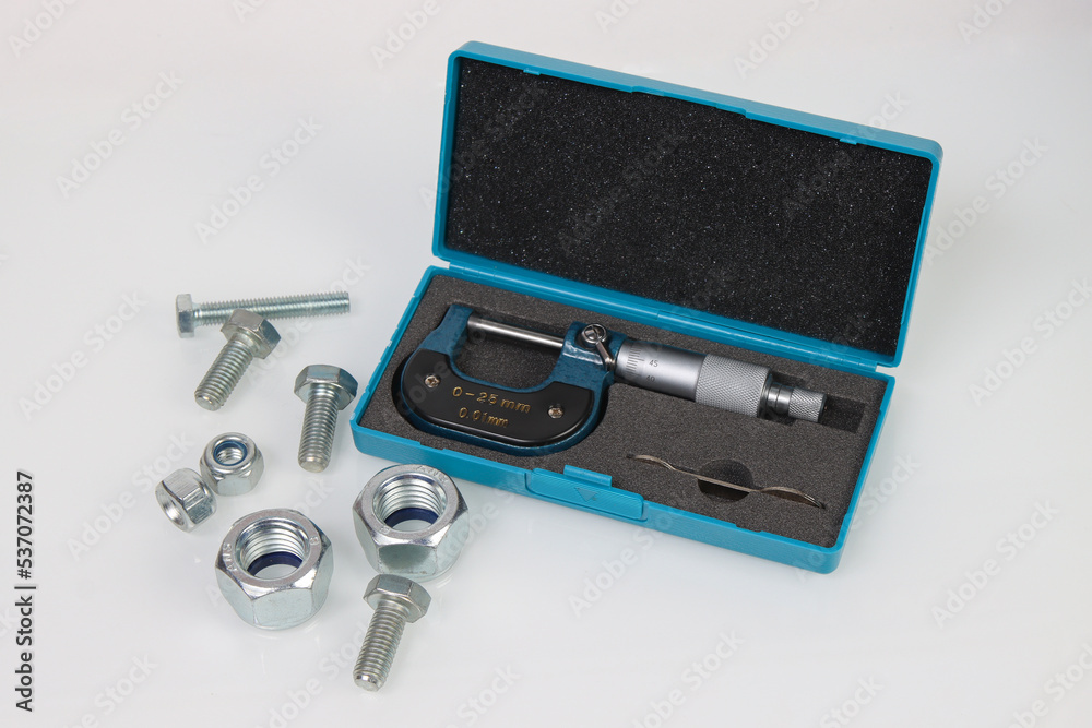 engineering micrometer and fastener on white background engineering micrometer and fastener on white background