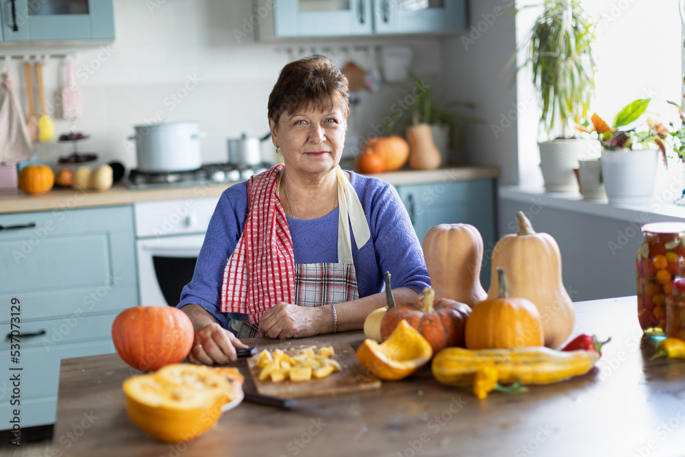 elderly woman cooking pumpkin elderly woman cooking pumpkin