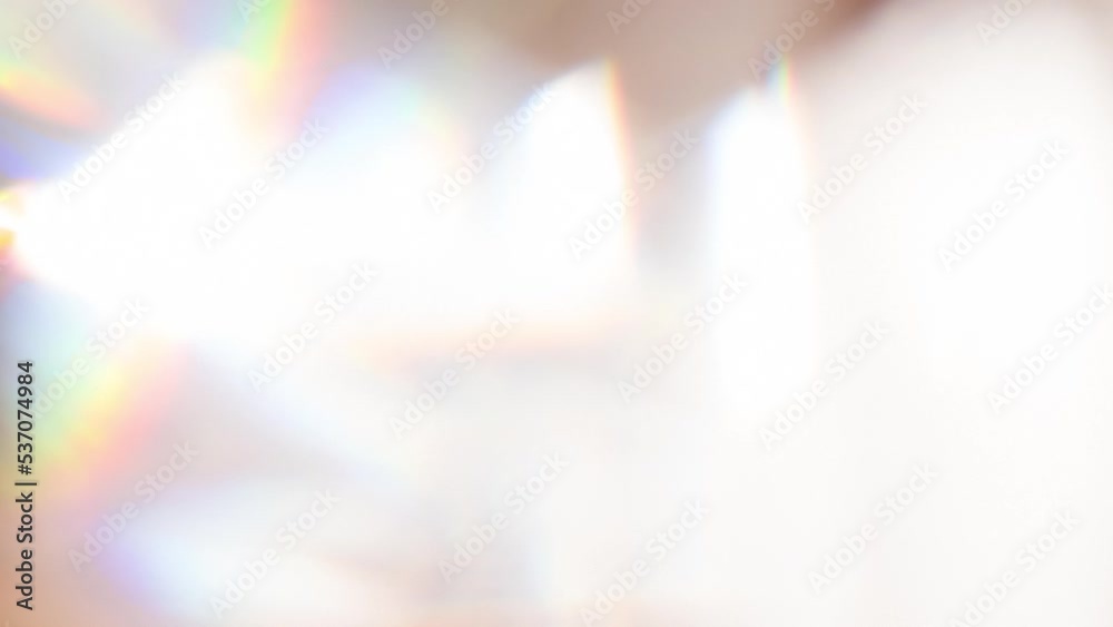 Optical Game of Faces Inside a Diamond. Loop. The light passes through the facets of a slowly rotating diamond and creates repetitive sparkling highlights and rainbow colors