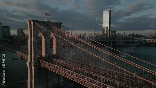 flying clockwise around Brooklyn Bridge at sunset