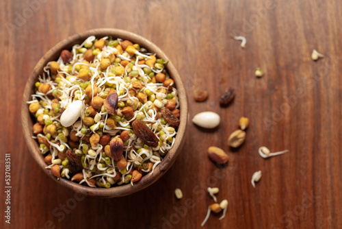 Close-up of A mix of organic sprout seeds sprouting ( germinating) bowl contains almond, groundnut, black gram, wheet, fenugreek and mung beens, in bowl in the studio