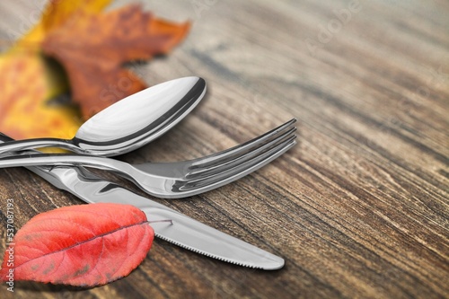 Colored autumn leaves with fork, spoon and knife
