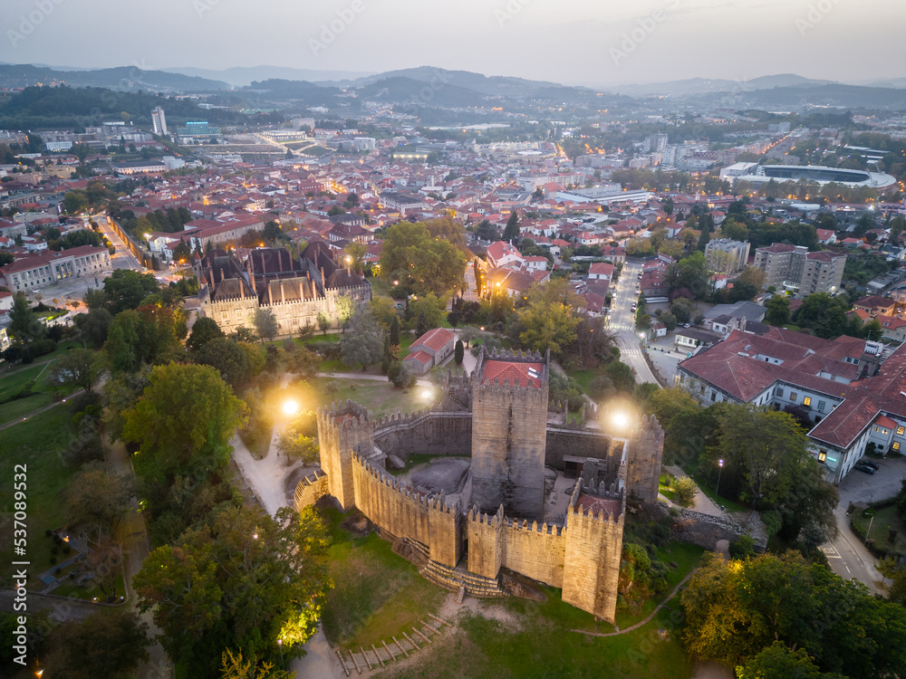 Aerial views of Guimaraes Castle. Cityscape seen from the air at sunset