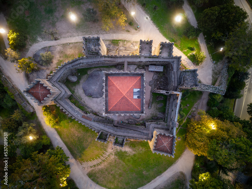 Aerial views of Guimaraes Castle. Cityscape seen from the air at sunset