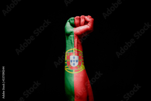 Man's hand in a fight signal with the countries flag. photo