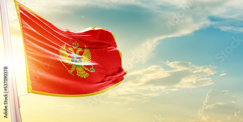 Montenegro national flag cloth fabric waving on the sky - Image