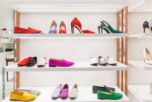 Elegant women's shoes on the shelves in a boutique. Shoes, boots and boots. Fashion & Style. Front view.