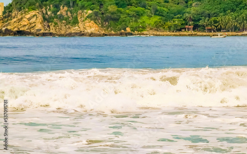 Extremely huge big surfer waves at beach Puerto Escondido Mexico. © arkadijschell