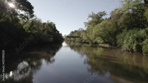 Smooth Neuse River Run in Morning Light Under a Bridge