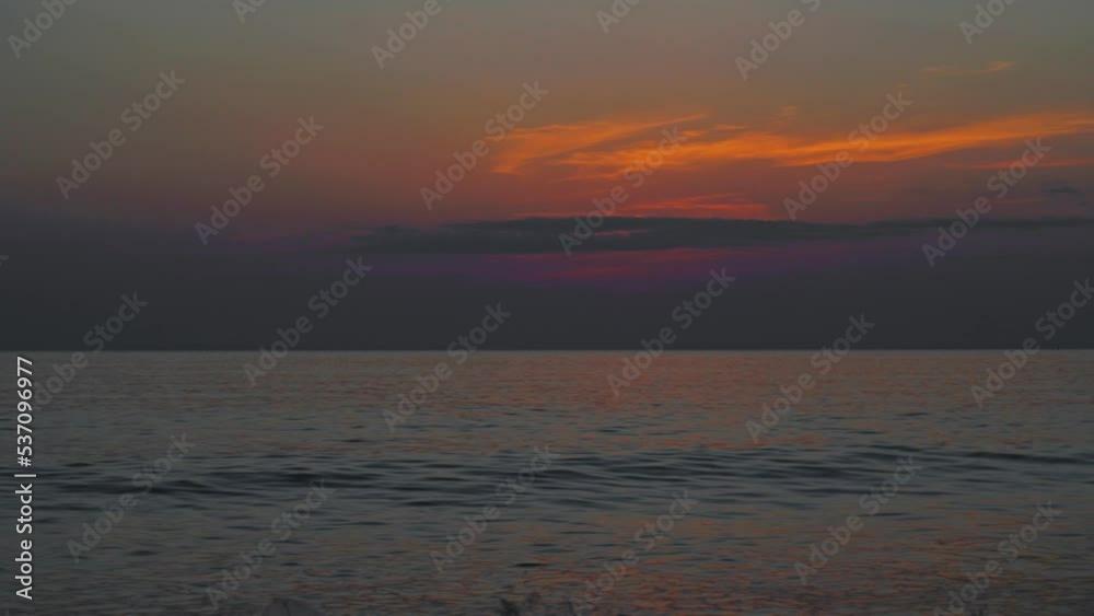 Time lapse colorful dark clouds at sunset over ocean or sea. Beautiful light of nature Amazing colors of setting sun Majestic clouds flowing in sky of sunrise Evening dark clouds, Night Time Laps