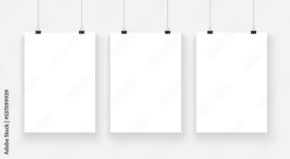 Three posters mockup with soft shadow. A4 sized paper frame mockup hanging with paper clip Three posters mockup with soft shadow. A4 sized paper frame mockup hanging with paper clip