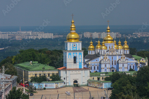 Monastery and church in Kiev viewed from far, with majestic city backdrop behind. Churches in kiev, blue church with golden roof