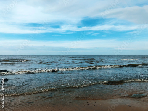 Cloudy blue sky above a blue surface of the sea.