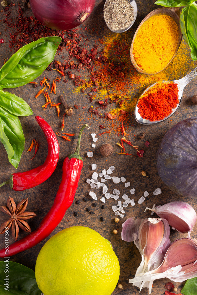 Variety of spices and herbs on table background. Cooking concept and ingredients at table top view Variety of spices and herbs on table background. Cooking concept and ingredients at table top view