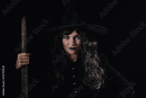 Portrait of black witch at night. Halloween masquerade costume  party decoration. Magic  classic hag