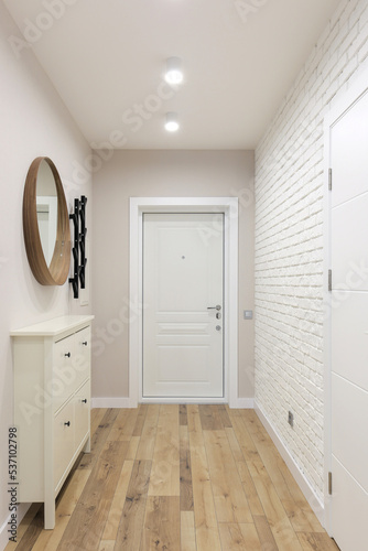 White entrance door inside an apartment interior