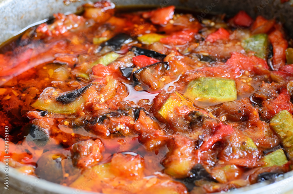 Vegetable stew of zucchini, bell pepper, carrot, onion, tomatoes and eggplant, selective focus, close-up Vegetable stew of zucchini, bell pepper, carrot, onion, tomatoes and eggplant, selective focus, close-up