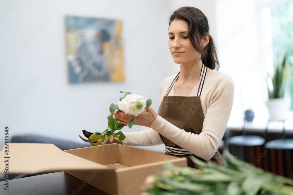 Florist working with flowers making a composition Florist working with flowers making a composition
