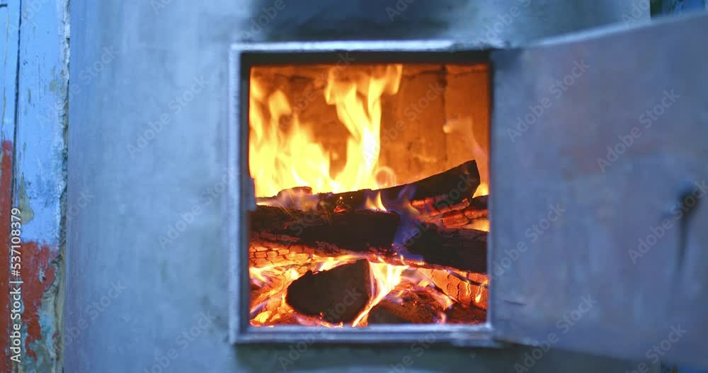 Logs are burning in a wood-burning stove, a red flame of fire. Charred firewood, cozy home, hearth, relaxing fire. 4k, ProRes Logs are burning in a wood-burning stove, a red flame of fire. Charred firewood, cozy home, hearth, relaxing fire. 4k, ProRes