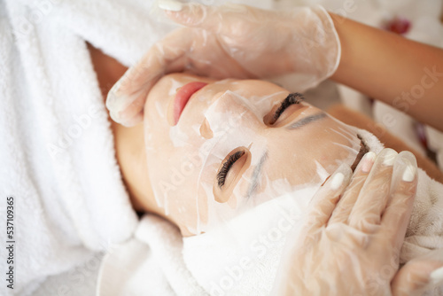 Young woman with cloth mask at spa salon