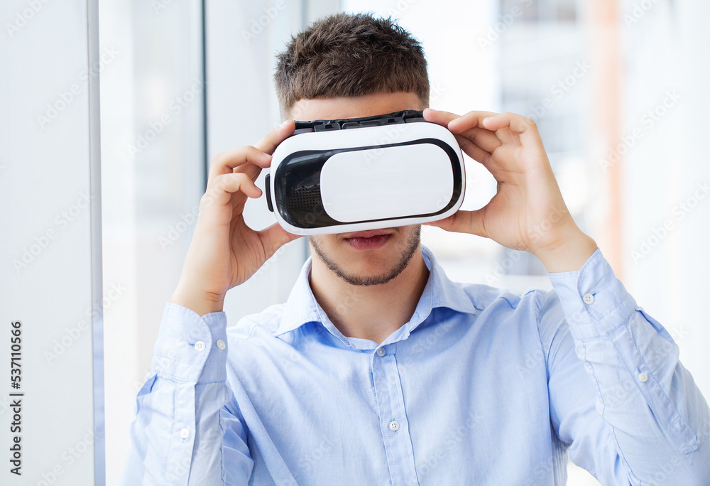 Young man using virtual reality headset at technology exhibition Young man using virtual reality headset at technology exhibition