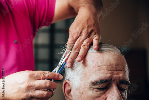 old man getting a haircut